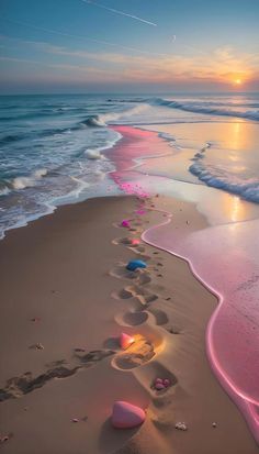 there are footprints in the sand on the beach near the water at sunset or sunrise