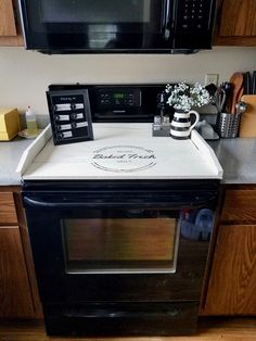 a microwave oven sitting on top of a counter next to a coffee pot and mug