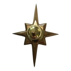 a metal star with a clock on it's side