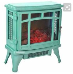 a small blue stove with red flames in it's front door and side shelves