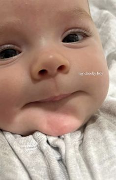 a close up of a baby smiling at the camera