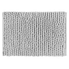 a white bath mat with small balls on the front and back of it, against a white background