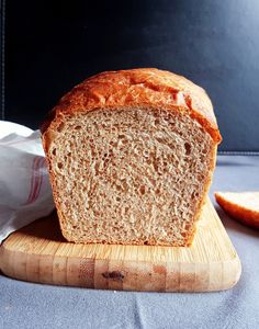 a loaf of bread sitting on top of a wooden cutting board