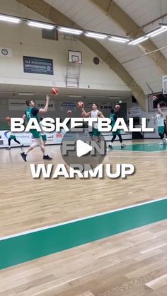 a group of young men playing basketball on top of a hard wood floor in a gym