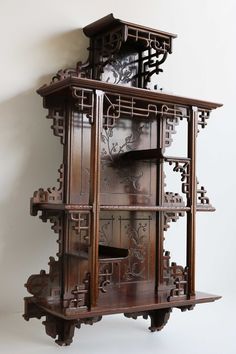 an ornate wooden shelf with many shelves on it