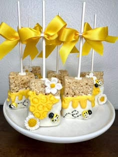 there is a cake made to look like bees and daisies on top of rice krispy treats