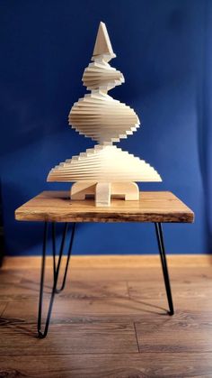 a wooden table topped with stacked books on top of it