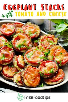 an eggplant salad with tomatoes and parsley on the side