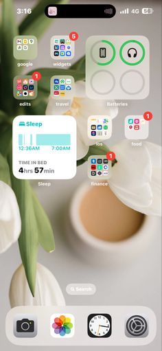 an iphone screen showing the time and icons for sleep, with flowers in the background