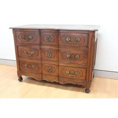 an old wooden dresser sitting on top of a hard wood floor