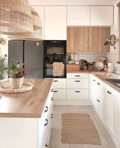 a kitchen with white cabinets and wooden counter tops, along with an area rug on the floor