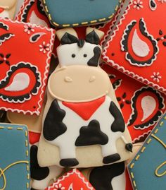 decorated cookies in the shape of cows and hearts