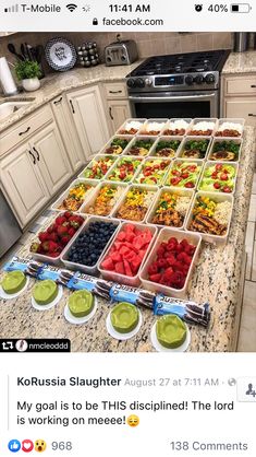 a counter top filled with trays of food on top of a kitchen counter next to an oven