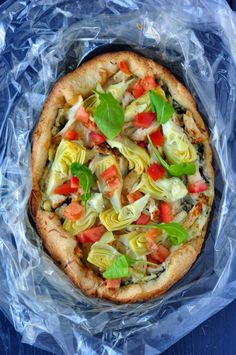 a pizza sitting on top of a plastic bag