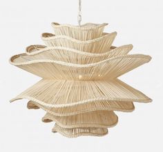 a light fixture made out of straw with an intricate design on the top and bottom