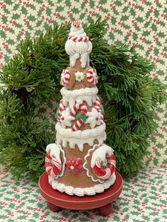 a christmas tree made out of gingerbreads and candy canes on a stand