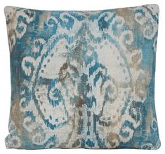 a blue and white pillow with an ornate design