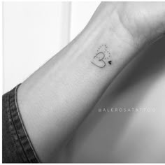 a small wrist tattoo with the letter c on it's left hand and a star in