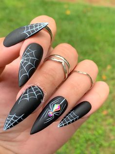 "Bling Spider Halloween Press on Nails Model: Long Flat stiletto Please read full description below. This set features:  White spiderwebs on a matte black background Bling spider accent nail on the ring finger Gel polish. I offer quality handcrafted press on nails designed with quality gel polish. This set will give you a perfect manicure within a few minutes for a small portion of the salon cost.  Sets come with 10 nails (based on the size/shape selected), nail prep kit, and instructions. Reusa Black Fingernails, Ongles Bling Bling, Nail Art Halloween, Spooky Black, Matte Black Nails, Makijaż Smokey Eye, Halloween Nail Designs, Halloween Nail Art