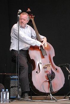 a man is playing an instrument on stage