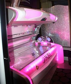 the interior of a futuristic vehicle with pink lights