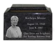 a black granite memorial block with an image of a woman in white on the front