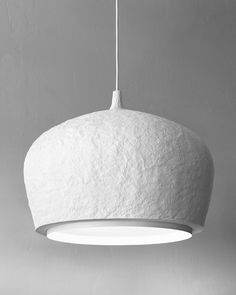 a large white light hanging from a ceiling