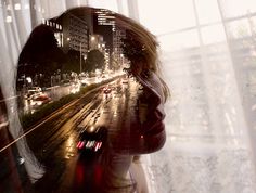 a woman's reflection is shown in the window