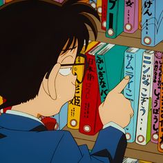 an anime character is looking at books in a bookcase and pointing to them with his finger