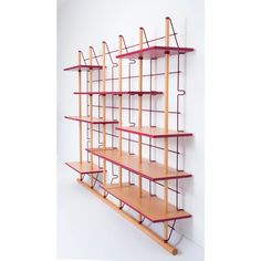 a wall mounted shelf with four shelves on each side