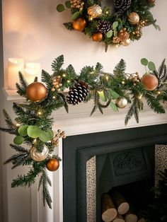 a fireplace decorated for christmas with pine cones, evergreens and other decorations on the mantel