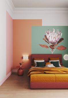 a bed sitting in a bedroom next to a wall with a flower painting on it