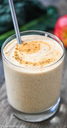 a smoothie in a glass with a metal straw