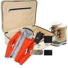 an open suitcase filled with clothing and accessories for winter travel on a white back ground