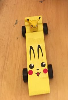 a paper mache with a pikachu face on it's front wheel