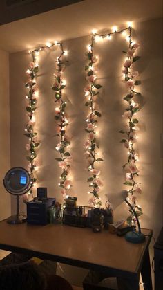 a desk with lights on it and some plants growing up the side of the wall