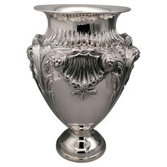 an ornate silver vase is shown on a white background