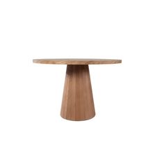 a round wooden table sitting on top of a white wall