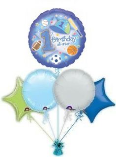 the 1st birthday balloon bouquet is filled with blue, green and white balloons