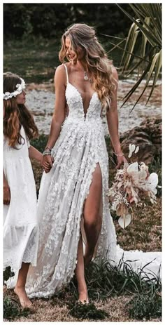 two women in white dresses holding hands