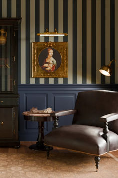 a chair and table in a room with striped walls