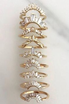 a stack of five rings sitting on top of a white table next to each other