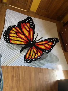 a butterfly made out of legos on the floor