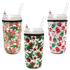 three christmas themed cups with straws in them