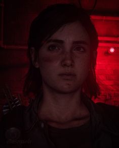 the last of us character standing in front of a red light