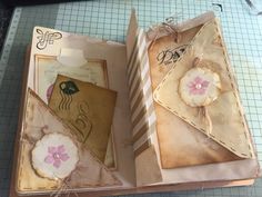 an open box with some cards inside on a table next to scissors and other crafting supplies