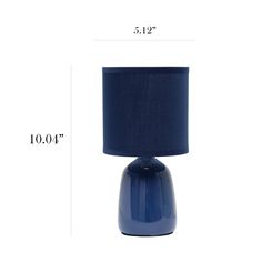 a blue table lamp sitting on top of a white floor next to a black lampshade