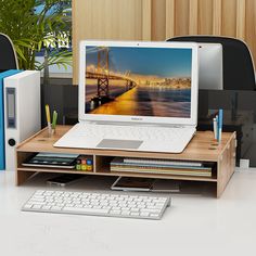 an open laptop computer sitting on top of a desk next to a keyboard and mouse