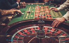 people playing roulejack at a casino table