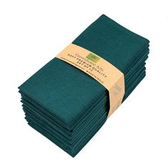 a stack of teal colored napkins with a brown label